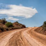 Desert dirt road and blue sky and cloud